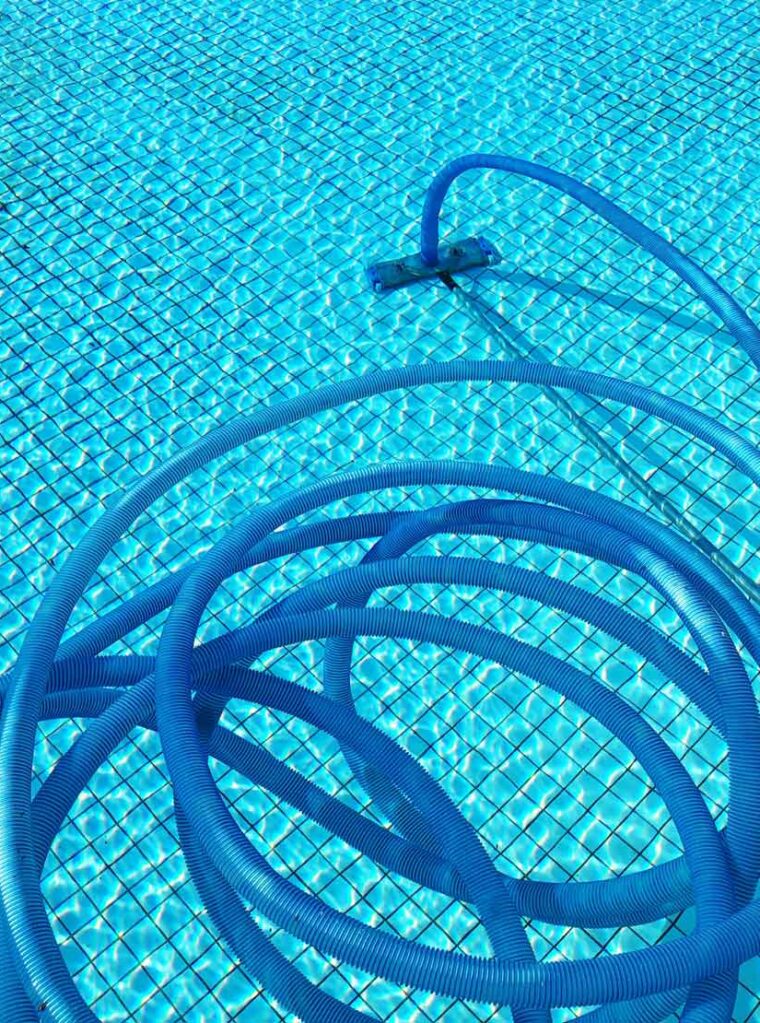 leaning tubes inside of a swimming pool cleaning the bottom